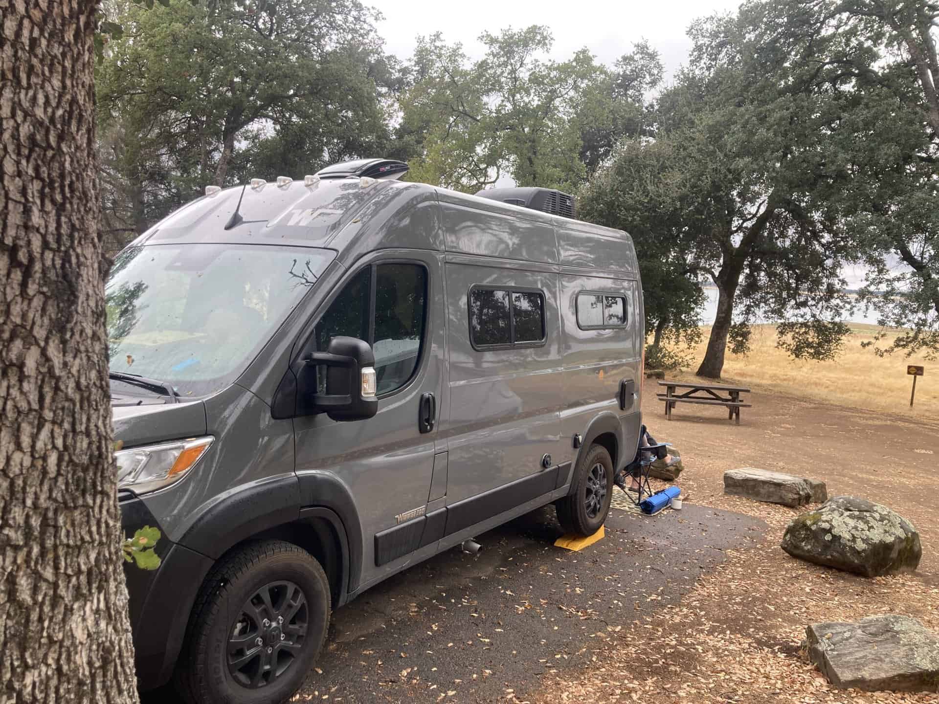 A view of our van from site 79 with the lake visible through the trees.