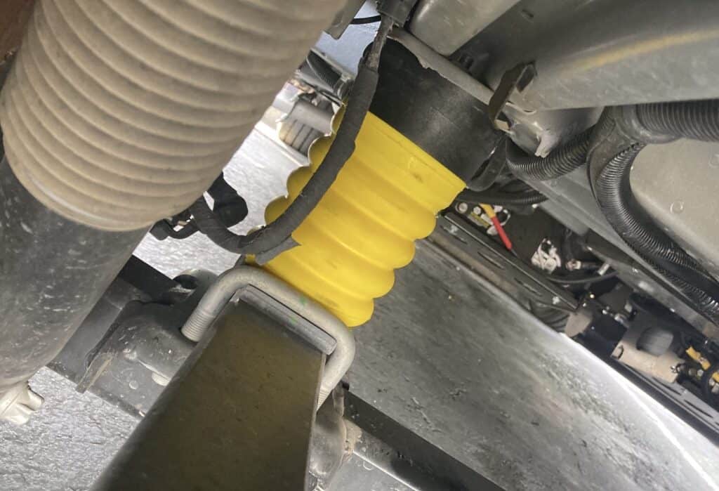 a yellow rear sumo spring on a ram promaster van