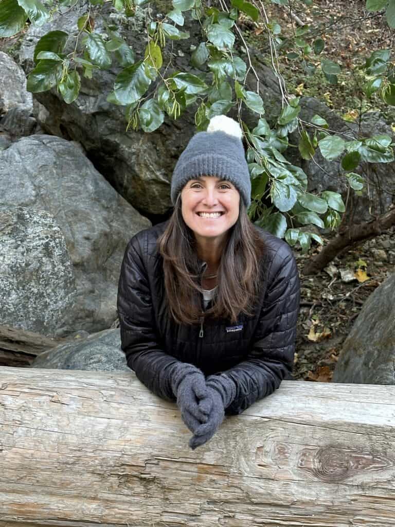 a beautiful woman dressed warmly smiling at the camera