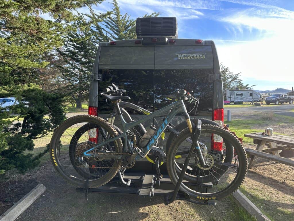 two bikes on a kuat bike rack off the rear of a van