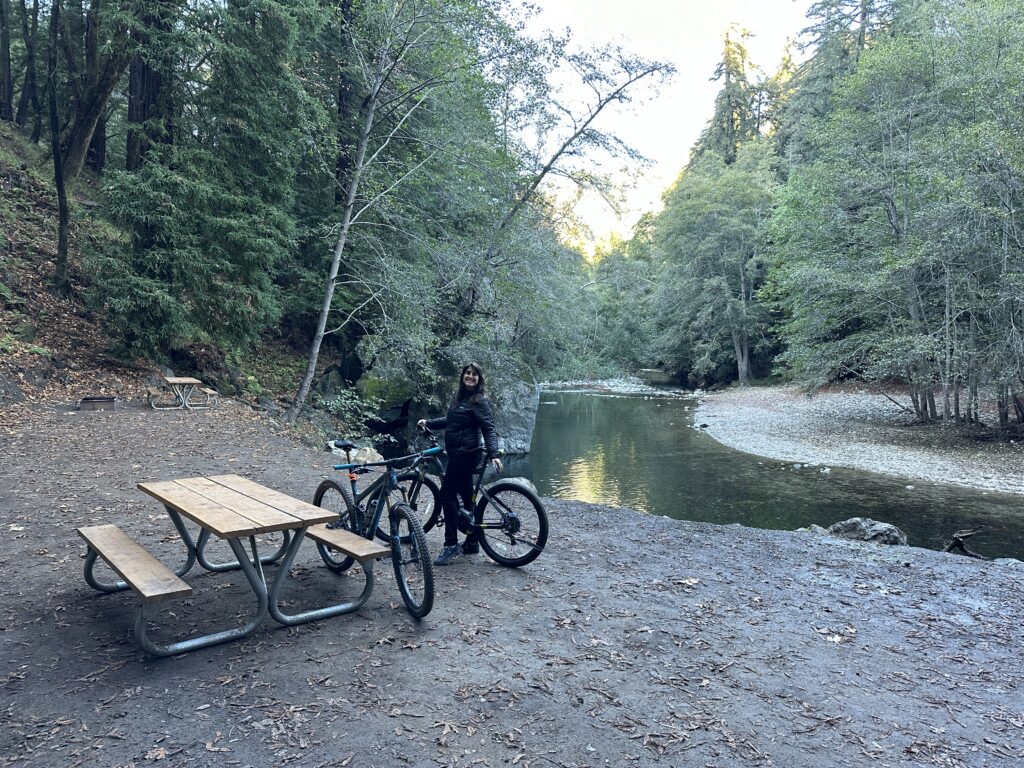 fernwood park campground with a mountain biker looking at the camera river in the background