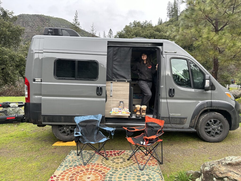 a side view of our promaster van at camp