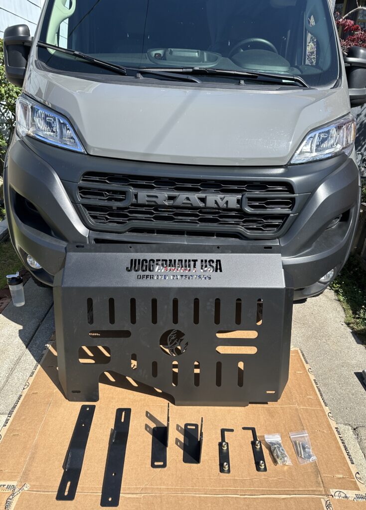 juggernaut skid plate and parts laid out in front of the van