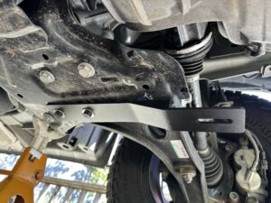 juggernaut skid plate bracket attached to the lower control arm