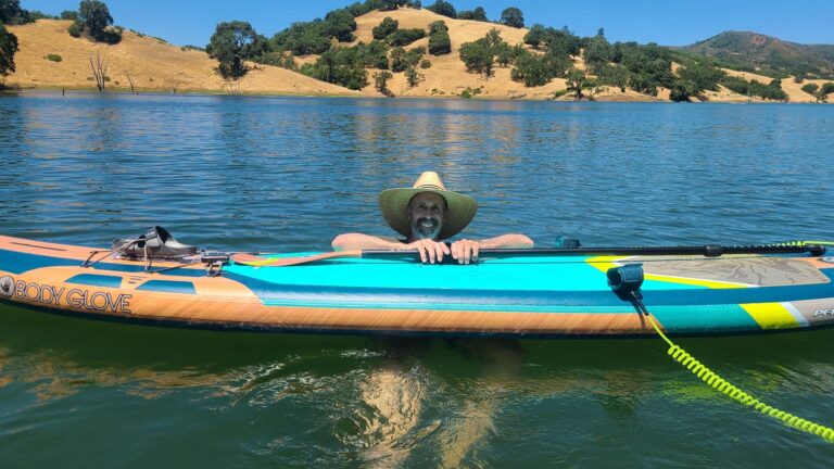 me in the water with my paddle board floating in front of me