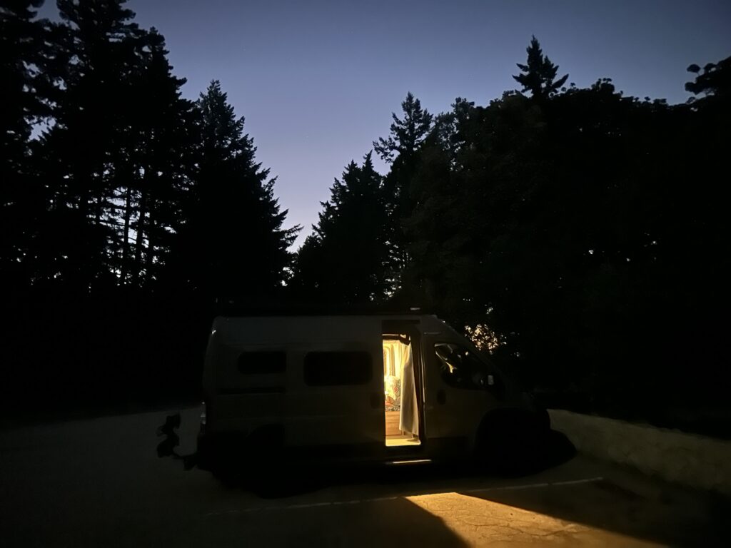 side view of my van at night with lights on inside and the side door open