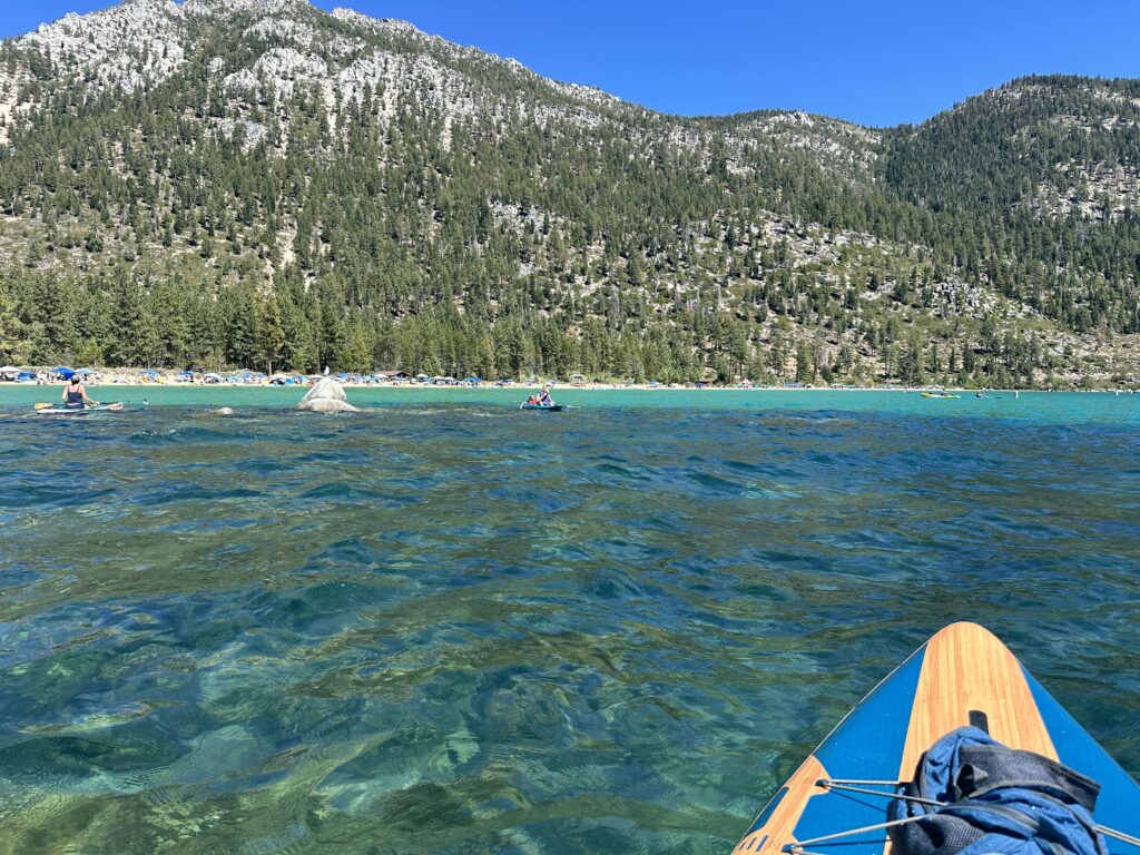 looking across the turquoise water to sandy harbor beach