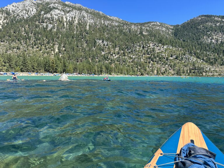 looking across the turquoise water to sandy harbor beach