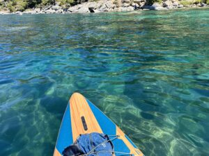 looking off the tip of the paddle board at the beautiful clear water