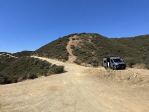 wide open dirt road with my van in the distance