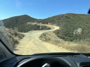 winding dirt road viewed through my front windshield